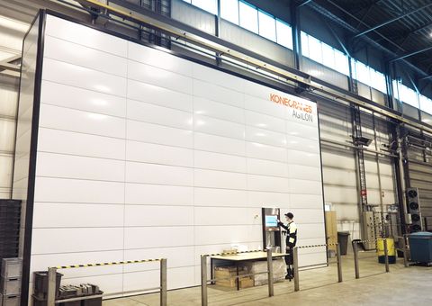 BE Group employee picking up items from the automated warehouse Agilon user access point.