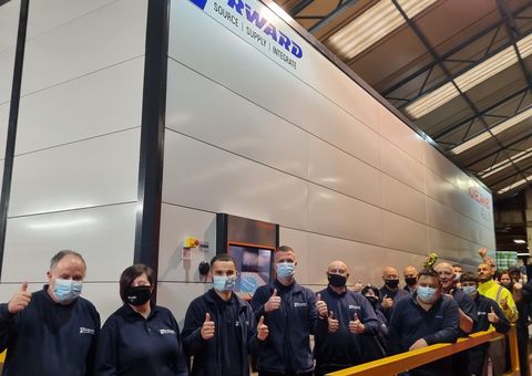 Forward Industrial Products Group workers thumbs up in front of the automated warehouse Agilon