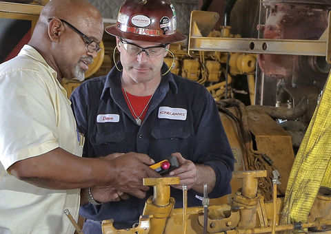 Konecranes technician and customer with crane remote