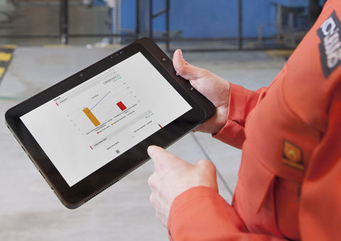 Konecranes technician holds tablet with yourKONECRANES