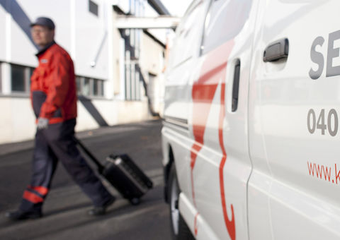 Konecranes technician walks past service truck
