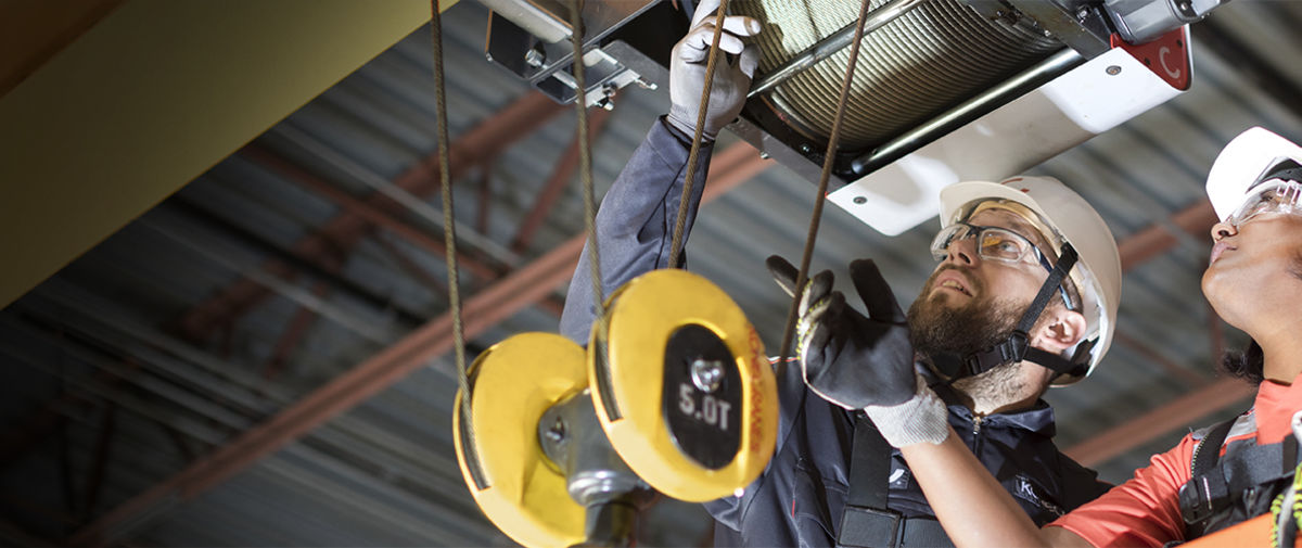 Konecranes technicians work on a hoist