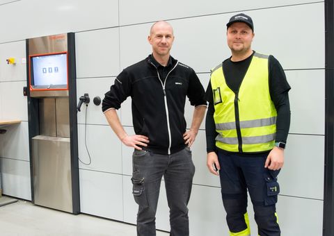 Valmet employees in front of Agilon automated warehouse, improving operational efficiency and smooth operations with Konecranes Agilon warehouse automation.