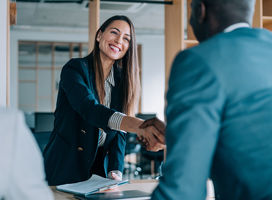 Woman and a man shaking hands.