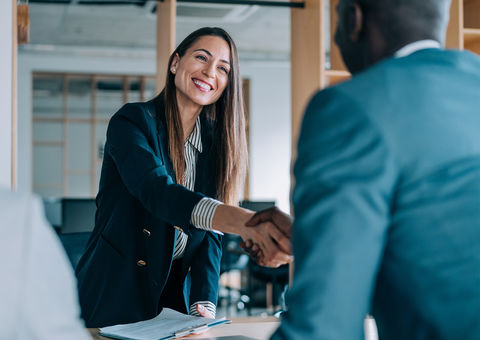Woman and a man shaking hands.