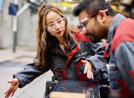 Woman and man working on Konecranes factory floor.  