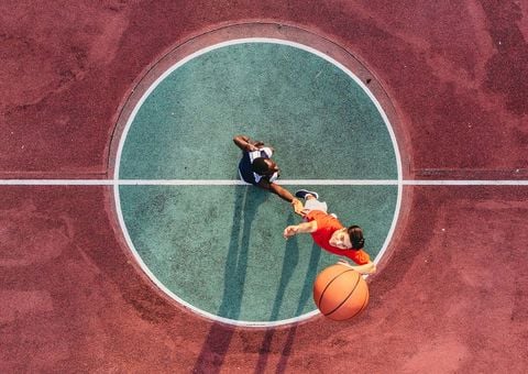 Two men playing basketball.